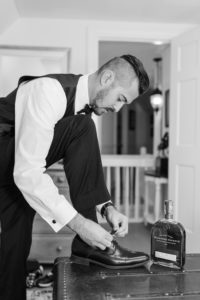 Documentary wedding photo of a groom preparing for the ceremony during an emotional wedding morning