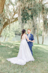 ride approaching groom for first look in garden setting during Atlanta wedding