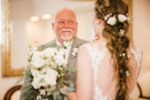 Father smiling at the bride during an emotional first look moment captured through documentary Atlanta wedding photography