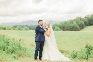 Emotional wedding photo of newlyweds embracing during a quiet moment together after the celebration in North Georgia Mountains.