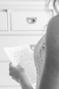 Emotional wedding photo of a bride reading a heartfelt letter while getting ready captured by a Luxury Atlanta Wedding Photographer