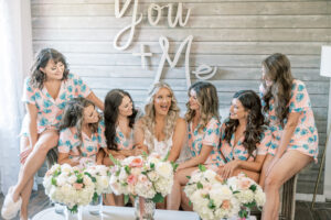 bridesmaids in matching pajamas laughing together during bridal getting ready photos in Atlanta