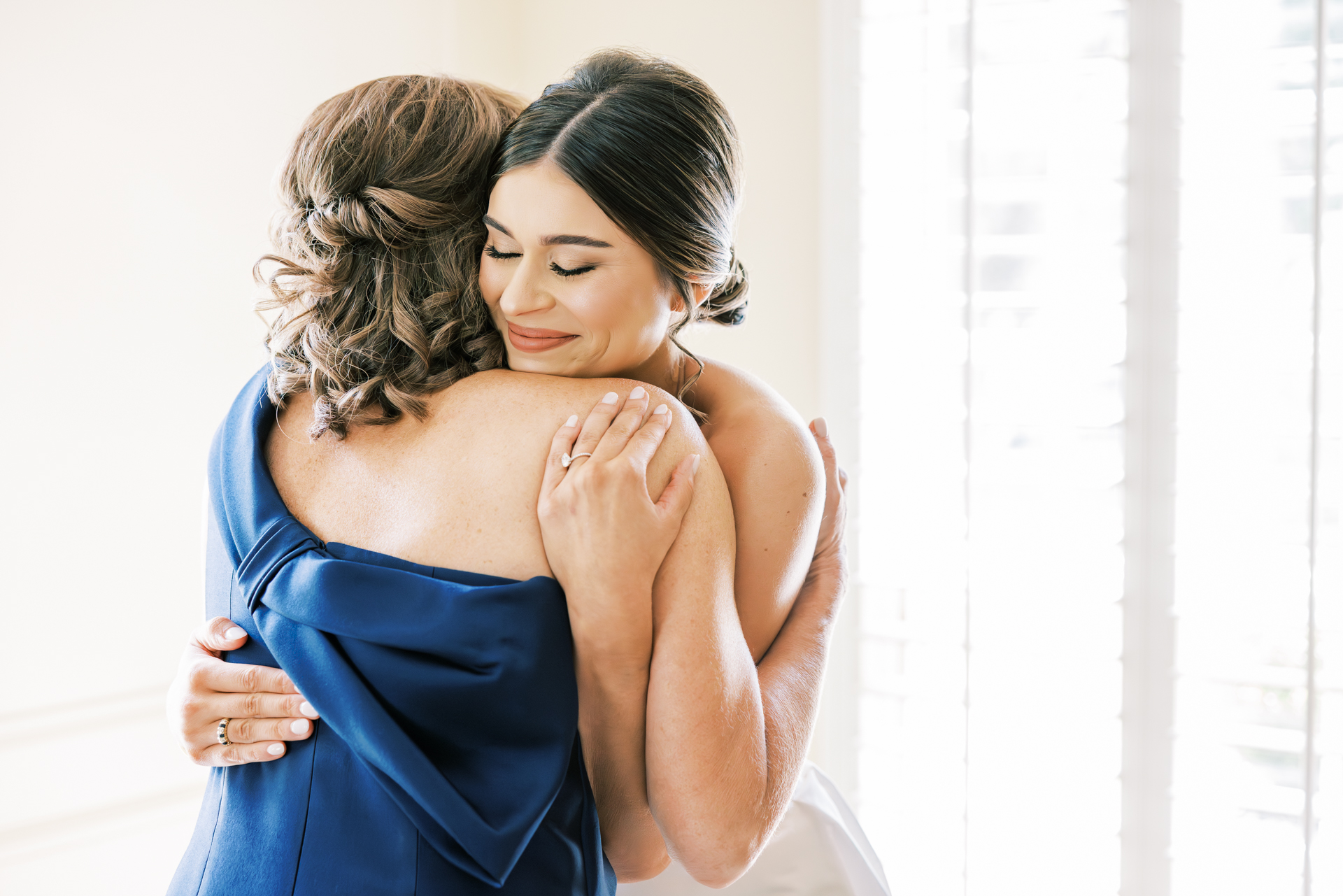emotional mother and bride embrace during wedding morning capturing joyful and timeless bridal getting ready photos in Atlanta