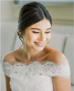 soft candid bridal moment of bride looking down with natural smile during getting ready in Atlanta