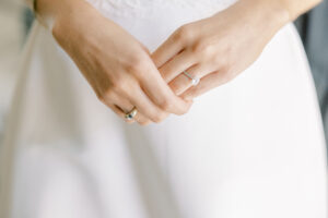 bridal hands detail featuring engagement ring captured in soft light during getting ready photos in Atlanta
