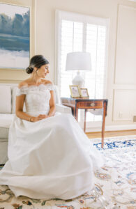 bridal portrait of bride seated in soft window light during peaceful getting ready moment in Atlanta