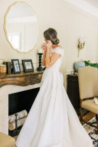 bride placing earrings during quiet wedding morning moment captured in soft natural light in Atlanta