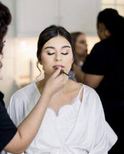 makeup artist applying bridal makeup during wedding morning getting ready photos in Atlanta