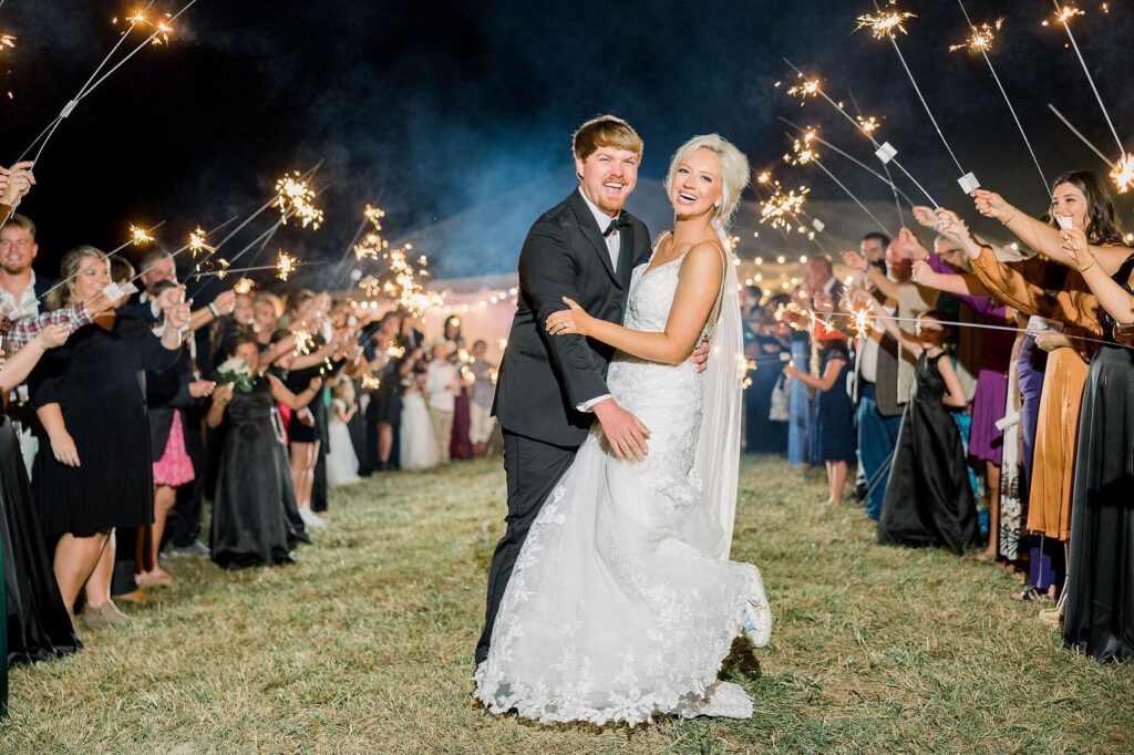 Bride and groom walking through sparkler send off at private estate wedding reception in Lake Mary
