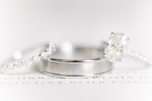 Elegant wedding rings photographed with soft natural light at Capital City Club wedding