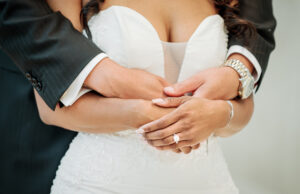 Close-up documentary wedding detail of bride and groom holding hands during luxury Swan House Atlanta wedding