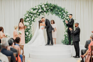 Emotional wedding ceremony first kiss at Swan House Atlanta History Center with joyful documentary photography
