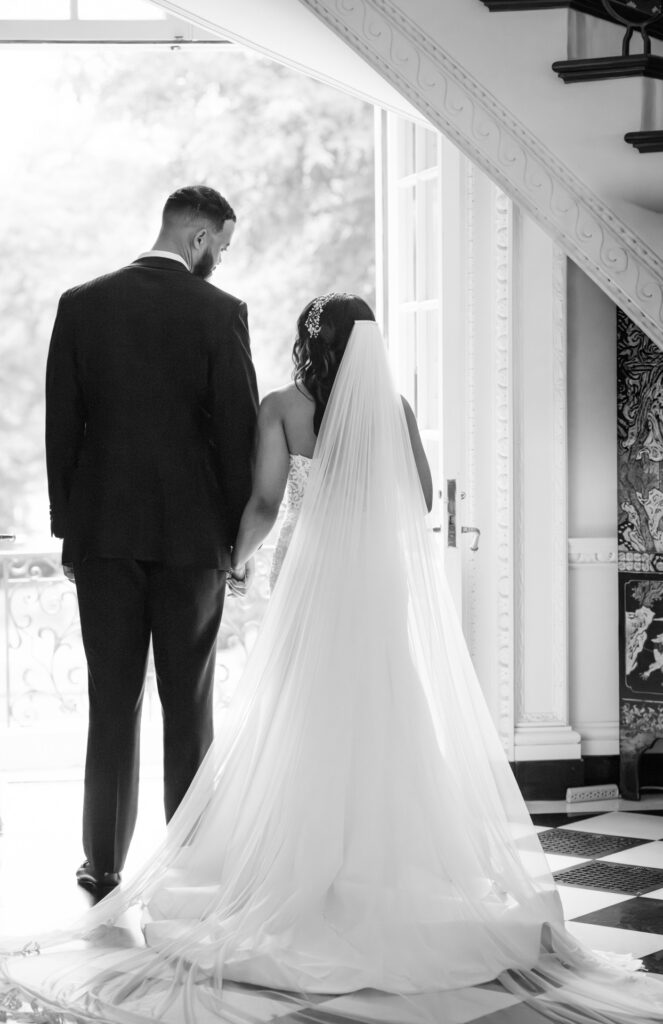 Romantic black and white wedding photo of bride and groom inside Swan House Atlanta History Center