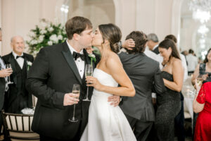 Bride and groom candid reception portrait with champagne and elegant wedding atmosphere