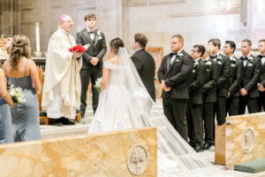 Wedding ceremony exchange at Christ the King Cathedral with timeless cathedral architecture