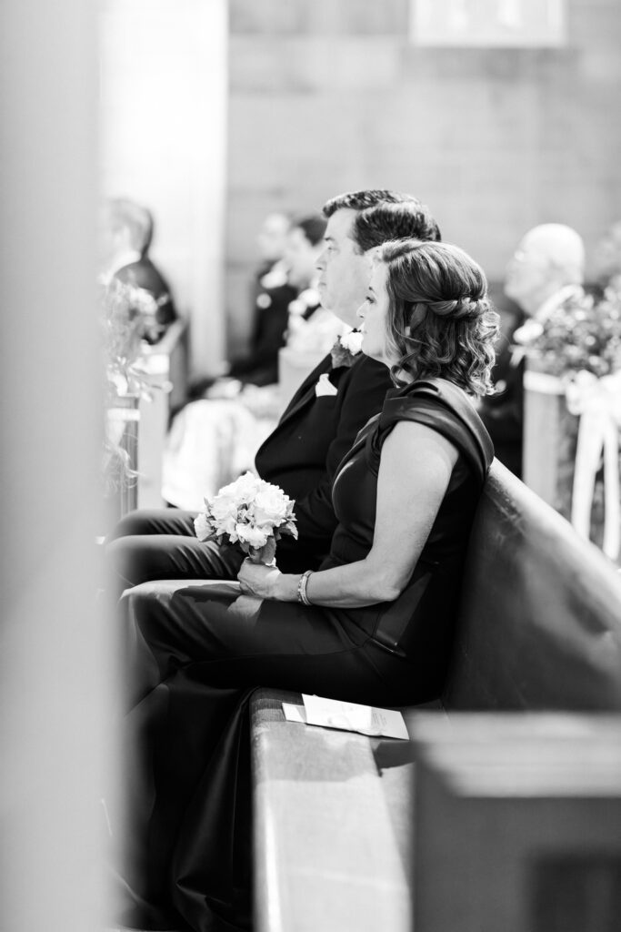 Emotional black and white brides mother and father reaction during Christ the King Cathedral ceremony