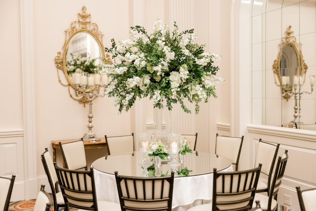 Luxury reception tablescape with white floral arrangements at Capital City Club wedding