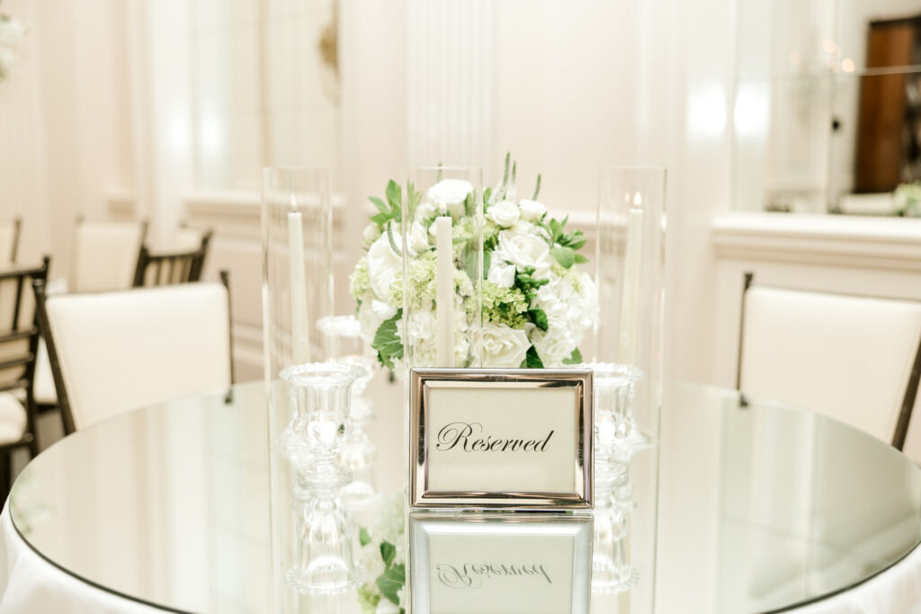 Elegant reserved reception table detail with candlelight and florals at Capital City Club Atlanta wedding
