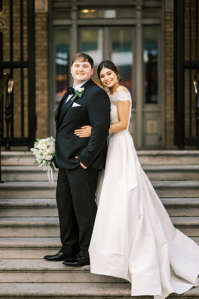 Elegant wedding portrait of bride and groom on the steps of Capital City Club Atlanta