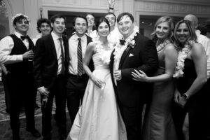 Black and white wedding reception portrait with friends and family celebrating together