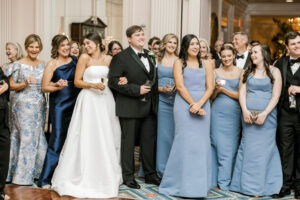 Bride and groom surrounded by wedding guests during lively reception in Atlanta Georgia