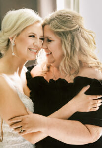 Bride sharing an emotional moment with a loved one during wedding preparations at a private estate wedding