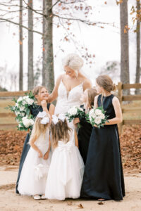 Bride sharing joyful moments with flower girls before her private estate wedding ceremony at Lake Mary