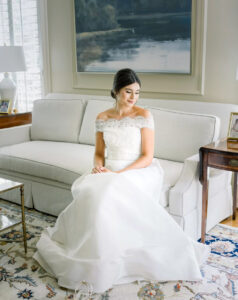 bridal portrait from alternate perspective with bride seated in soft window light during getting ready in Atlanta