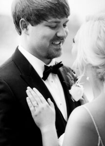 Emotional wedding photo of a groom smiling during an intimate newlywed moment