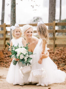 Bride posing with flower girls outdoors during a private Lake Mary wedding celebration