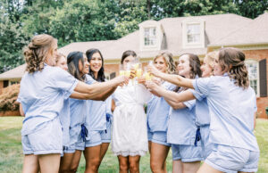 bridal party in coordinated pajamas posing together in soft natural light during getting ready photos in Atlanta