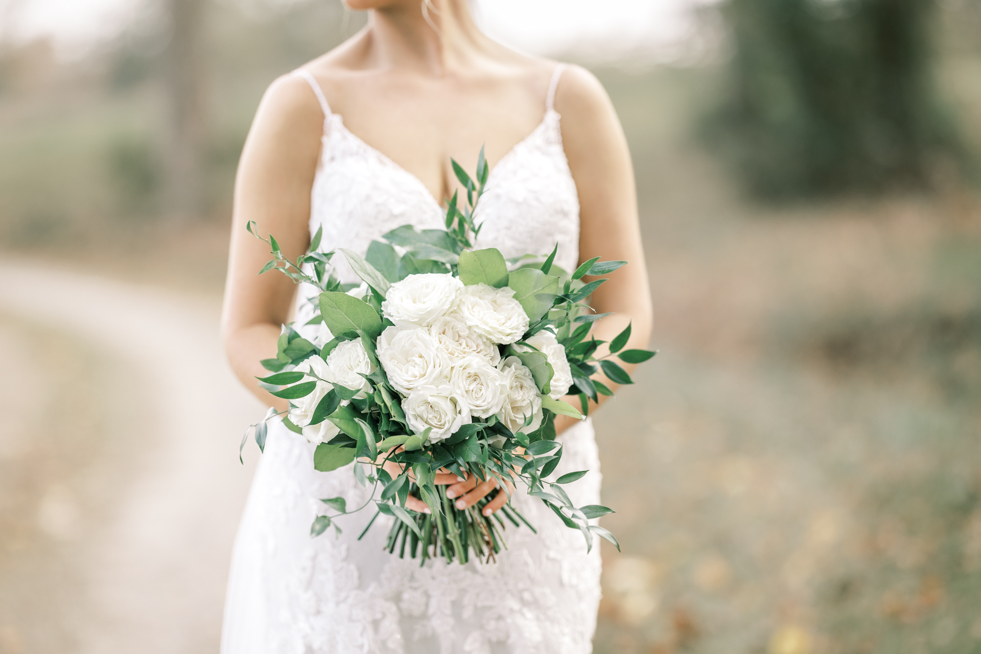 Editorial bridal portrait featuring white rose bouquet during a private Lake Mary wedding