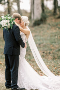 Bride embracing groom with flowing veil during romantic portraits at a private Lake Mary wedding