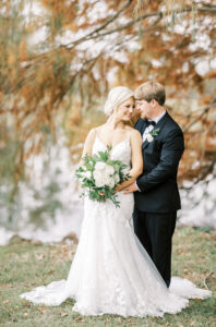 Full length portrait of bride and groom embracing during a private estate wedding at Lake Mary