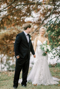 Groom smiling at bride during romantic outdoor portraits at a private Lake Mary wedding