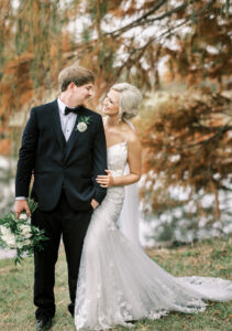 Bride and groom walking together beside the lake during a private estate wedding at Lake Mary