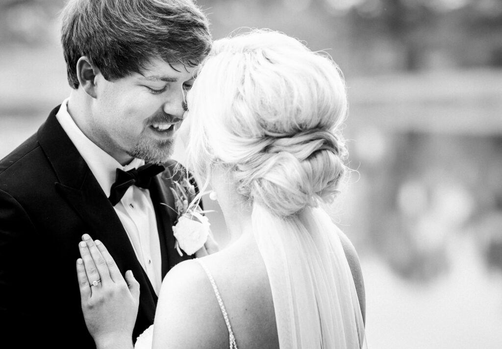 Black and white close-up portrait of bride and groom embracing during a private Lake Mary wedding