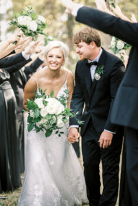 Bride smiling while walking with groom during a joyful private estate wedding celebration at Lake Mary