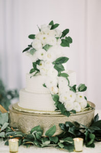Elegant white wedding cake with floral details at a private estate wedding reception in Lake Mary