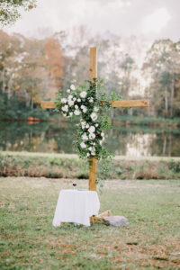 Floral ceremony cross beside the lake during a private estate wedding at Lake Mary
