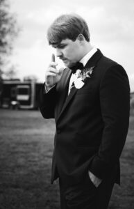Groom standing alone before walking down the aisle during a private estate wedding at Lake Mary
