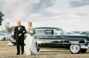 Bride walking toward her ceremony with grandfather during a private Lake Mary wedding celebration