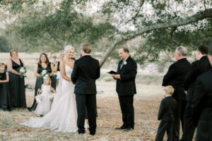 Bride and groom standing together during their outdoor private estate wedding ceremony at Lake Mary