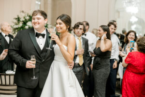 Joyful wedding reception moment with bride smiling on crowded dance floor in Atlanta