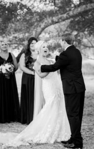 Bride laughing during an emotional outdoor wedding ceremony at a private Lake Mary estate