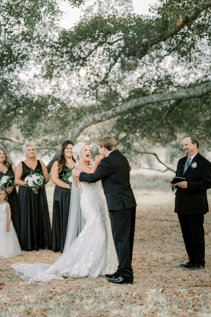 Luxury Atlanta Wedding Photographer capturing an emotional first kiss filled with laughter and joy