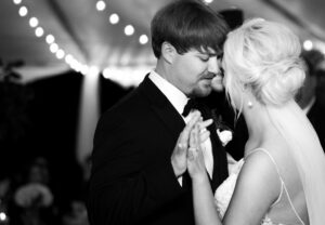 Black and white portrait of bride and groom dancing during a private estate wedding reception in Lake Mary