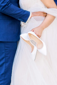 Close-up portrait of bride holding her wedding shoes at Swan House captured by a luxury documentary Atlanta wedding photographer