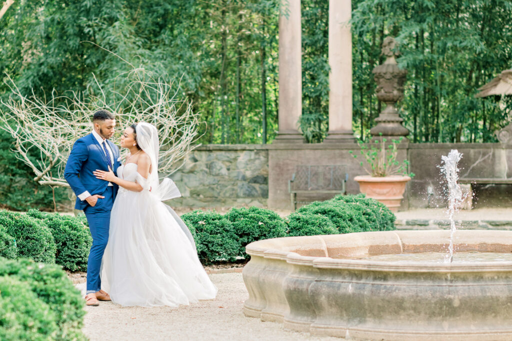 Bride and groom sharing a romantic moment near the iconic Swan House fountain captured by a luxury documentary Atlanta wedding photographer in Atlanta