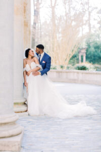 Editorial bride and groom portrait beneath elegant Swan House architecture captured by a luxury documentary Atlanta wedding photographer